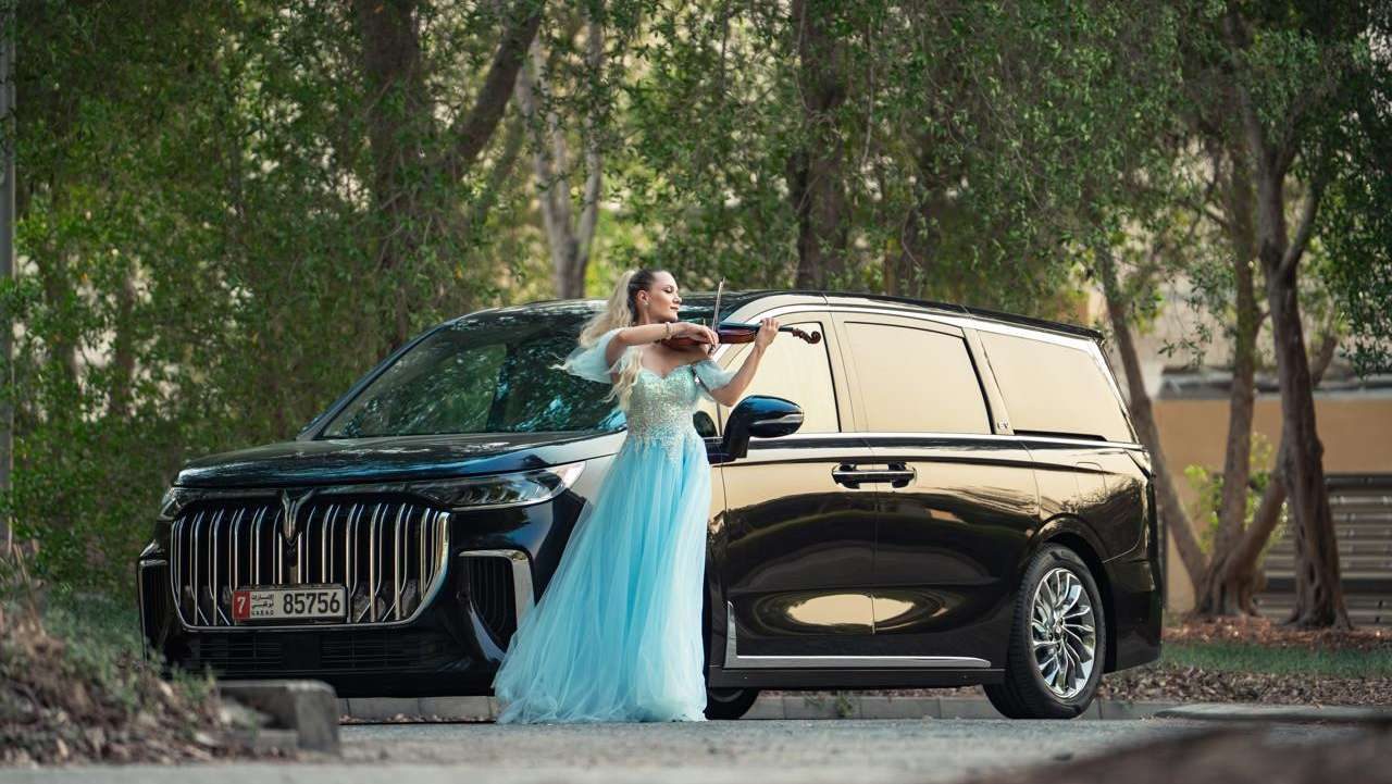 VOYAH luxury MPV with a violinist in a blue gown, from the UAE launch campaign